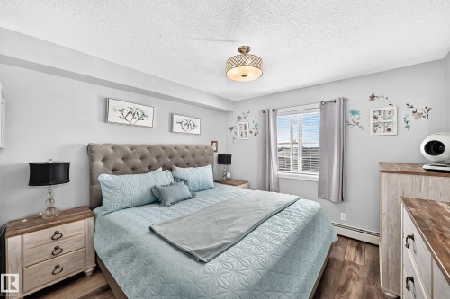 Wood-finish flooring with light-toned walls - #401 5390 Chappelle Rd Sw, Edmonton, AB 