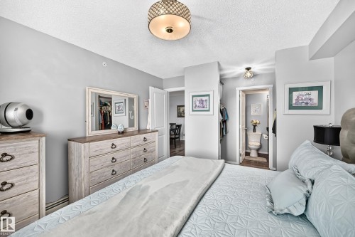 Recessed lighting, light-toned wall finishes, and a decorative ceiling fixture - #401 5390 Chappelle Rd Sw, Edmonton, AB 
