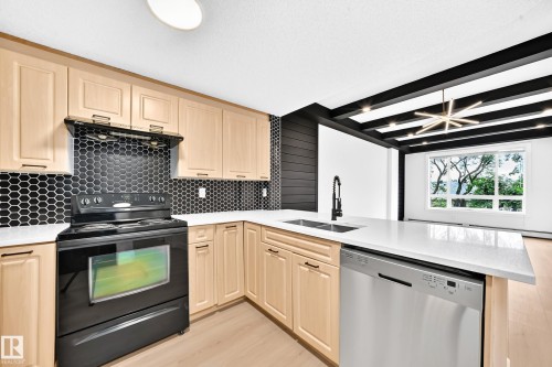 #323 6315 135 Av Nw, Edmonton, AB - Indoor Photo Showing Kitchen With Double Sink