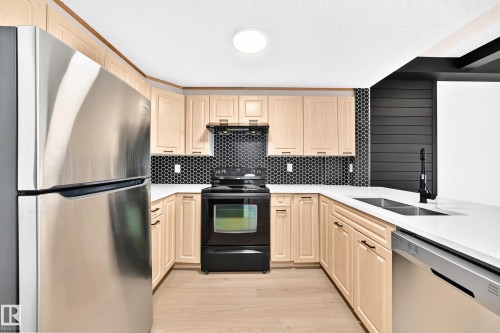 #323 6315 135 Av Nw, Edmonton, AB - Indoor Photo Showing Kitchen With Double Sink