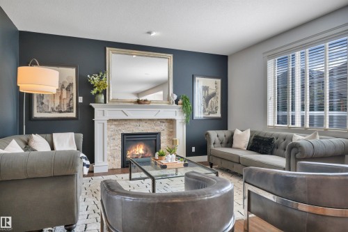 4231 Savaryn Drive Sw, Edmonton, AB - Indoor Photo Showing Living Room With Fireplace