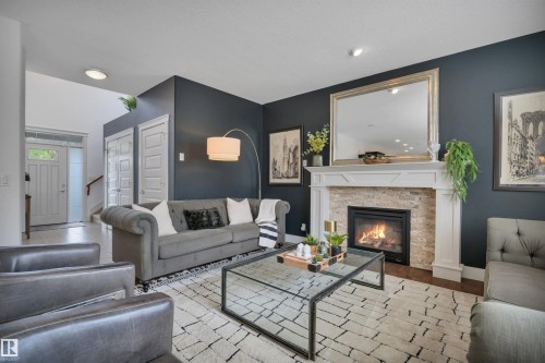 4231 Savaryn Drive Sw, Edmonton, AB - Indoor Photo Showing Living Room With Fireplace