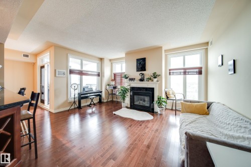 #1301 9020 Jasper Av Nw, Edmonton, AB - Indoor Photo Showing Living Room With Fireplace
