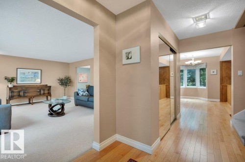 Hardwood flooring & mirrored closet doors - 5620 151 Street Nw, Edmonton, AB - Indoor Photo Showing Other Room