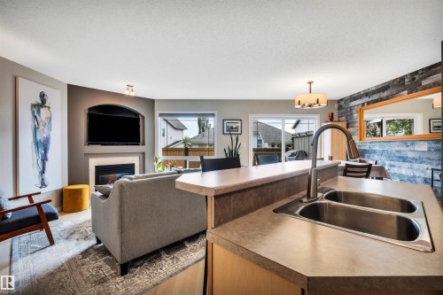#12 20 Norman Ct, St. Albert, AB - Indoor Photo Showing Kitchen With Fireplace With Double Sink