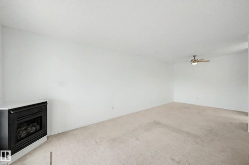 #452 10520 120 Nw, Edmonton, AB - Indoor Photo Showing Other Room With Fireplace