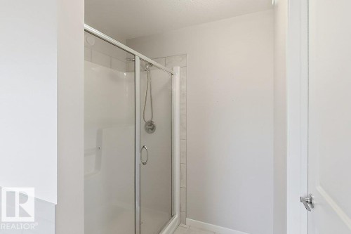 Shower enclosure with clear glass doors and chrome hardware - 4242 Chichak Close Sw, Edmonton, AB - Indoor Photo Showing Bathroom