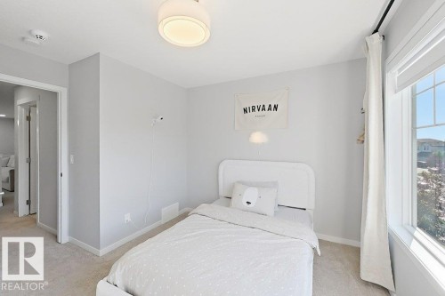 Recessed window with white trim, light gray painted walls, and light-colored carpet flooring - 4242 Chichak Close Sw, Edmonton, AB - Indoor Photo Showing Bedroom
