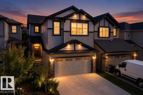 Multi-level facade with mixed siding and dark trim accents, featuring multiple dormers and a prominent entry - 4242 Chichak Close Sw, Edmonton, AB - Outdoor