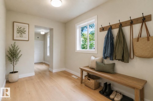 Wood-finish flooring, white trim, recessed ceiling light, built-in coat rack, and window with natural light - 12337 128 Avenue Nw, Edmonton, AB - Indoor Photo Showing Other Room