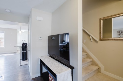 Carpeted staircase with a white handrail - 124 Cy Becker Boulevard Nw, Edmonton, AB - Indoor Photo Showing Other Room