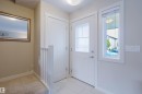 Entryway featuring a white door with frosted glass panels, a full-length sidelight, and light-toned tile flooring - 124 Cy Becker Boulevard Nw, Edmonton, AB  - Indoor Photo Showing Other Room 