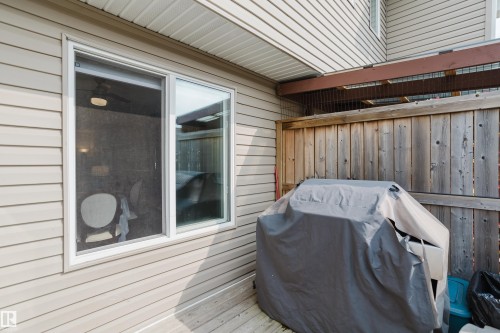 Exterior siding with a white-framed window unit - 124 Cy Becker Boulevard Nw, Edmonton, AB - Outdoor With Deck Patio Veranda With Exterior