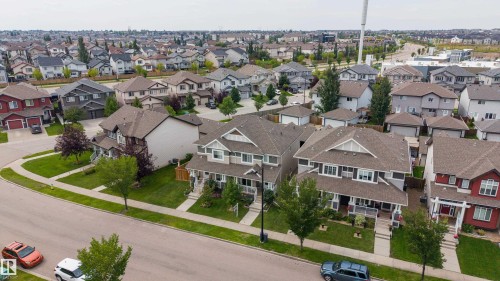 Residential neighborhood featuring a curvilinear street design, detached single-family homes, and established landscaping - 124 Cy Becker Boulevard Nw, Edmonton, AB - Outdoor With Facade