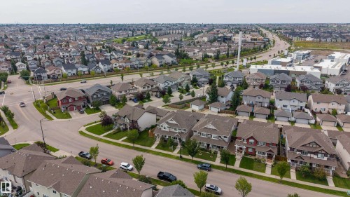 Residential neighborhood featuring a variety of single-family homes, tree-lined streets, and paved roadways - 124 Cy Becker Boulevard Nw, Edmonton, AB - Outdoor With View