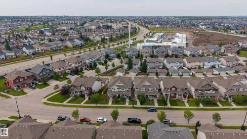 Expansive suburban residential neighborhood featuring a variety of single-family homes and a commercial development - 124 Cy Becker Boulevard Nw, Edmonton, AB - Outdoor With View