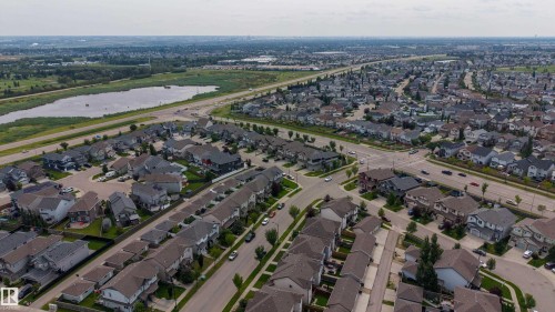 Expansive neighborhood featuring residential homes, paved streets, and a large natural water body - 124 Cy Becker Boulevard Nw, Edmonton, AB - Outdoor With View