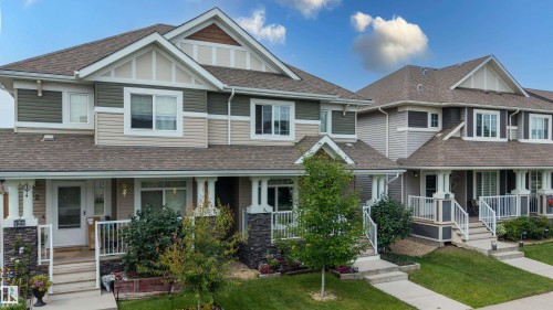 Multi-level facade featuring varied siding materials, gabled rooflines, and individual covered front porches with white railings - 124 Cy Becker Boulevard Nw, Edmonton, AB - Outdoor With Facade