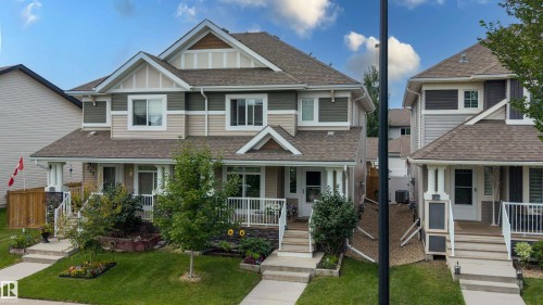 Multi-level exterior with dormer windows, stone accent pillars, front porch, and mature landscaping - 124 Cy Becker Boulevard Nw, Edmonton, AB - Outdoor With Deck Patio Veranda With Facade