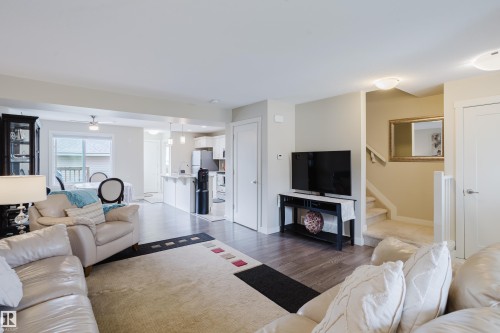 Open concept living space featuring wood-finish flooring, light neutral wall tones, and recessed lighting - 124 Cy Becker Boulevard Nw, Edmonton, AB - Indoor Photo Showing Living Room