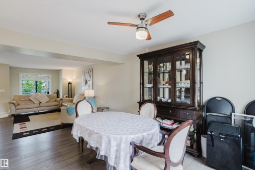 Spacious room featuring wood-finish flooring, a ceiling fan with light fixture, and neutral wall tones - 124 Cy Becker Boulevard Nw, Edmonton, AB - Indoor Photo Showing Dining Room