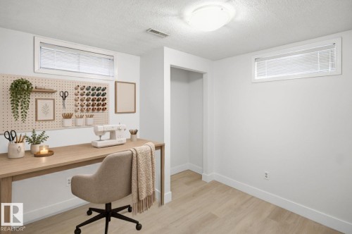 Recessed windows with blinds, light wood-finish flooring, white walls, and a built-in recessed opening - 3515 20 Ave Nw, Edmonton, AB - Indoor Photo Showing Office