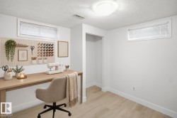 BEDROOM 4- Recessed windows with blinds, light wood-finish flooring, white walls, and a built-in recessed opening - 