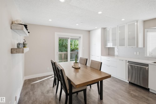 Modern kitchen with white cabinetry and integrated appliances - 3515 20 Ave Nw, Edmonton, AB - Indoor