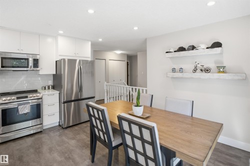 Modern kitchen with stainless steel appliances, white cabinetry, light-toned backsplash, and recessed lighting - 3515 20 Ave Nw, Edmonton, AB - Indoor