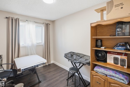 Wood-finish flooring, light-toned walls, and a window with natural light - 3515 20 Ave Nw, Edmonton, AB - Indoor
