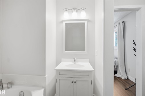 Vanity with an integrated sink, polished chrome faucet, and white countertop - 3515 20 Ave Nw, Edmonton, AB - Indoor Photo Showing Bathroom