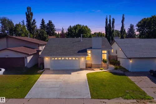 Contemporary exterior with a double-car attached garage, paved driveway, and established landscaping - 3515 20 Ave Nw, Edmonton, AB - Outdoor