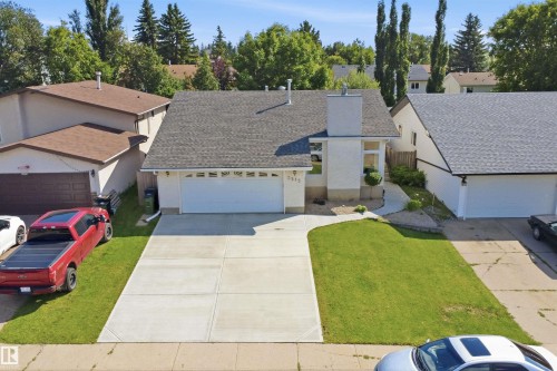 Single-story residence featuring an attached garage, paved driveway, and established front lawn - 3515 20 Ave Nw, Edmonton, AB - Outdoor