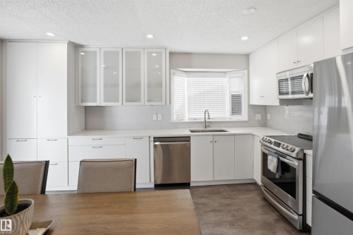 Modern kitchen featuring white cabinetry, stainless steel appliances, a bay window, and recessed lighting - 3515 20 Ave Nw, Edmonton, AB - Indoor Photo Showing Kitchen With Upgraded Kitchen