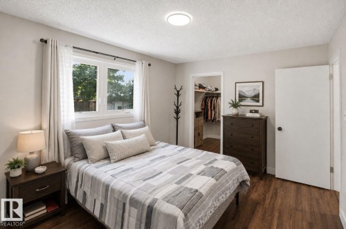 Wood-finish flooring, white trim, recessed lighting, and a built-in closet with shelving - 3515 20 Ave Nw, Edmonton, AB - Indoor Photo Showing Bedroom