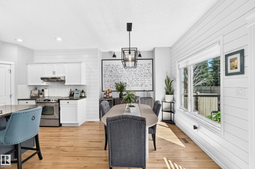 Bright dining area featuring wood-finish flooring and shiplap accent walls - 823 77 Street Sw, Edmonton, AB - Indoor