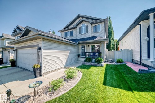 Two-story residence featuring light gray siding and a dark shingled roof - 823 77 Street Sw, Edmonton, AB - Outdoor With Deck Patio Veranda