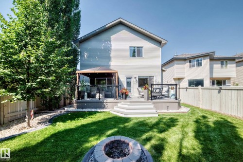 Multi-level deck with a covered gazebo and glass panel railings - 823 77 Street Sw, Edmonton, AB - Outdoor With Deck Patio Veranda