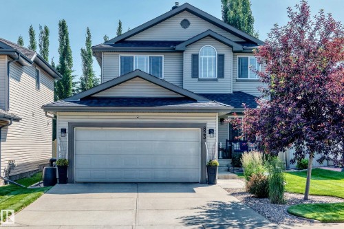 Two-story residence featuring siding exterior and a prominent two-car garage - 823 77 Street Sw, Edmonton, AB - Outdoor