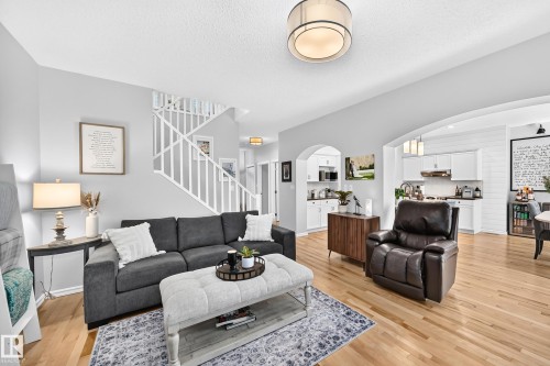 Bright open-concept living space with light-toned wood flooring - 823 77 Street Sw, Edmonton, AB - Indoor Photo Showing Living Room