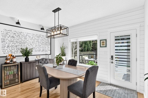 Dining area featuring light wood-finish flooring and white shiplap accent walls - 823 77 Street Sw, Edmonton, AB - Indoor Photo Showing Dining Room