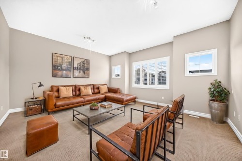 Neutral tone wall paint, recessed lighting, white window frames, white window blinds, and carpeted flooring - 4212 Charles Close Sw, Edmonton, AB - Indoor Photo Showing Living Room