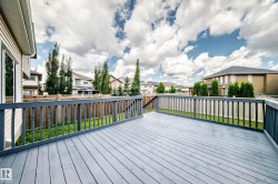 Spacious outdoor deck with a gray wood-finish surface and matching railings - 
