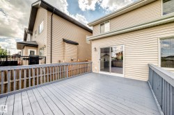 Spacious wood-finish deck with slatted railings, directly accessible via sliding glass doors - 
