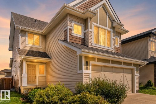 Two-story exterior with light-colored siding and mixed material facade - 4212 Charles Close Sw, Edmonton, AB - Outdoor