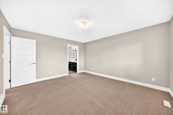 Spacious interior featuring neutral wall tones and a textured ceiling - 