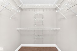Dedicated storage space featuring multiple white wire shelving units and a textured carpeted floor - 
