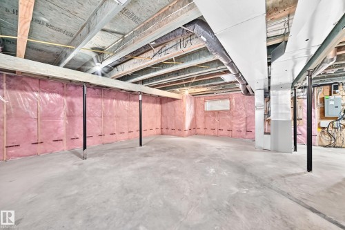 Unfinished basement featuring exposed wood joists, concrete flooring, insulated walls, and a visible electrical panel - 4212 Charles Close Sw, Edmonton, AB - Indoor Photo Showing Basement