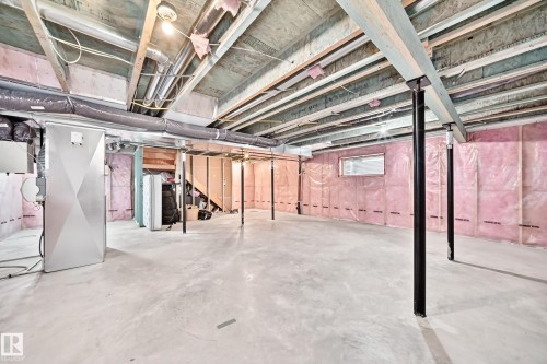 Expansive unfinished lower level with concrete flooring, visible wood joists, and insulated walls - 4212 Charles Close Sw, Edmonton, AB - Indoor Photo Showing Basement
