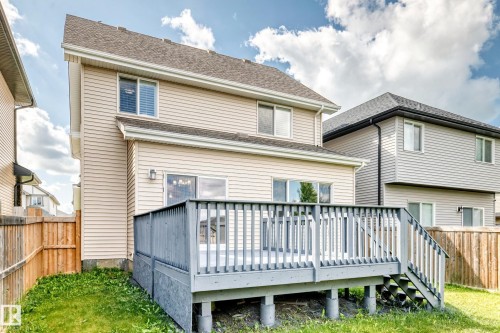 Rear exterior with a multi-level deck featuring painted wood construction and steps - 4212 Charles Close Sw, Edmonton, AB - Outdoor With Deck Patio Veranda